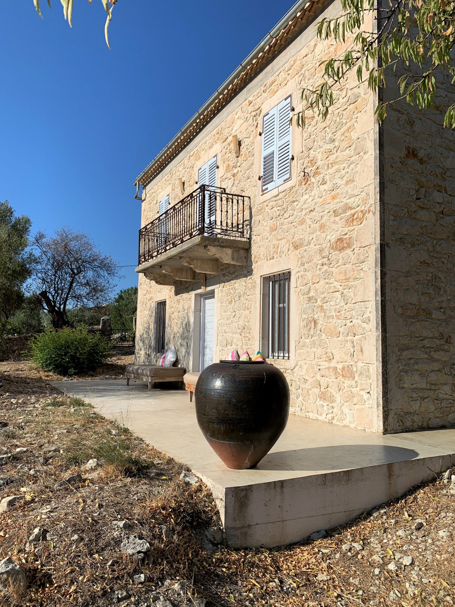Exterior facade of stone built Villa Kalos and outside courtyard for rent, Ithaca Greece Lahos