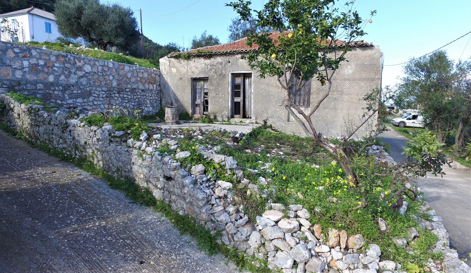 Road view of house for sale in Ithaca Greece Kolleri