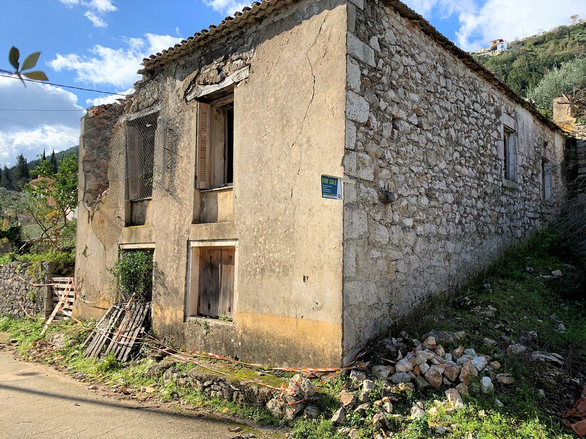 Road view of house for sale in Ithaca Greece Kolleri