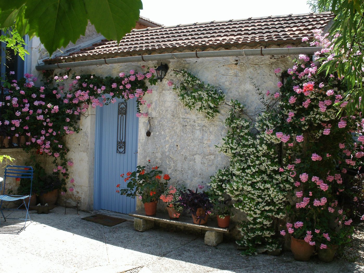 Stone exterior and flower detail of house for sale Ithaca Greece, Lahos