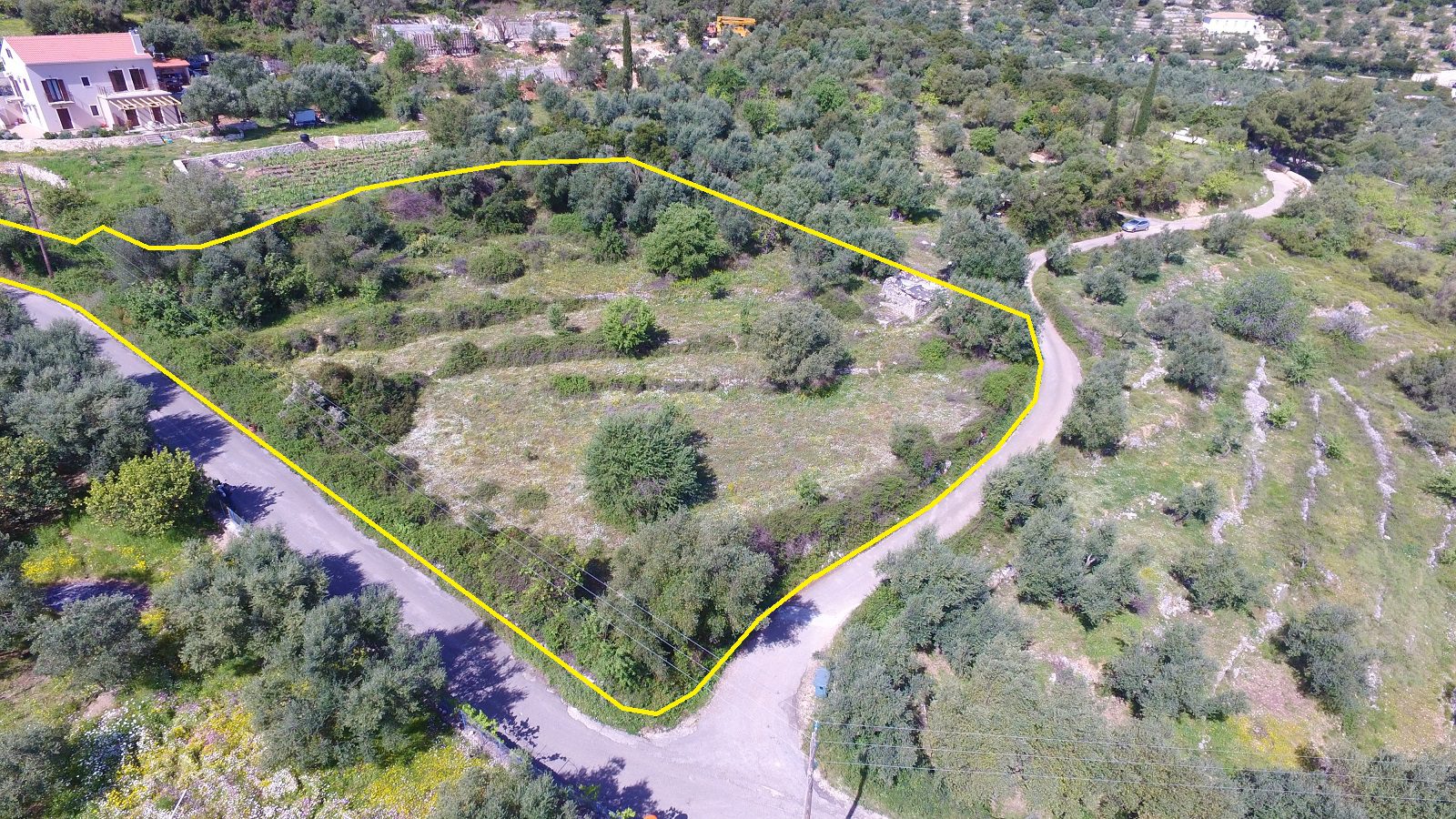 Aerial view and border of land with building license for sale in Ithaca Greece, Perachori