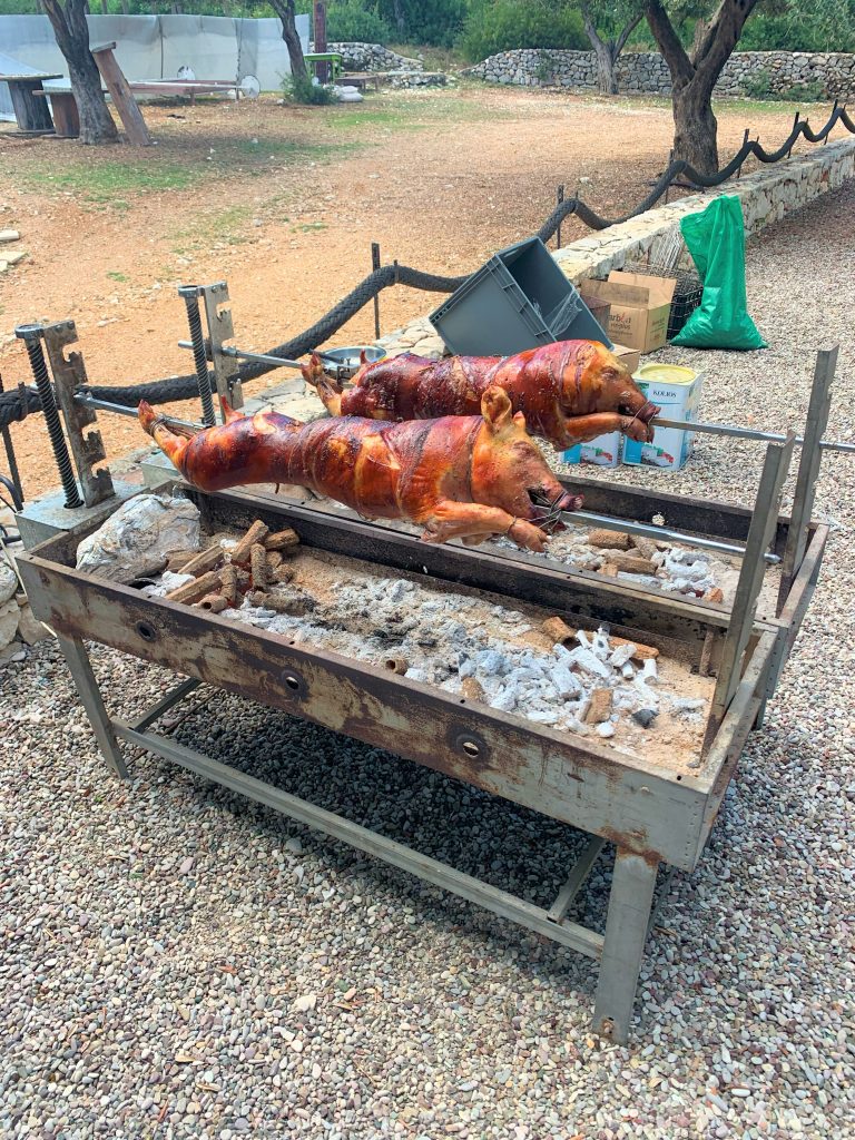 piglets on spit, birthday party, Filiatro beach, Ithaca Greece