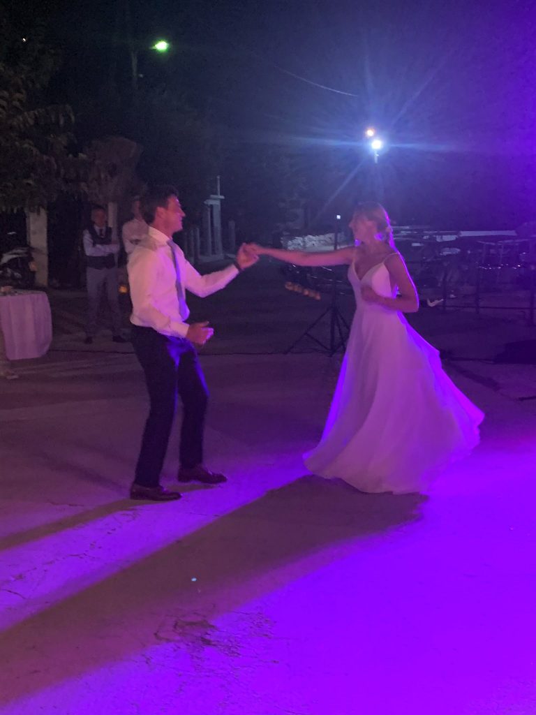 Bride and groom dance, wedding reception at beach, Ithaca, Greece