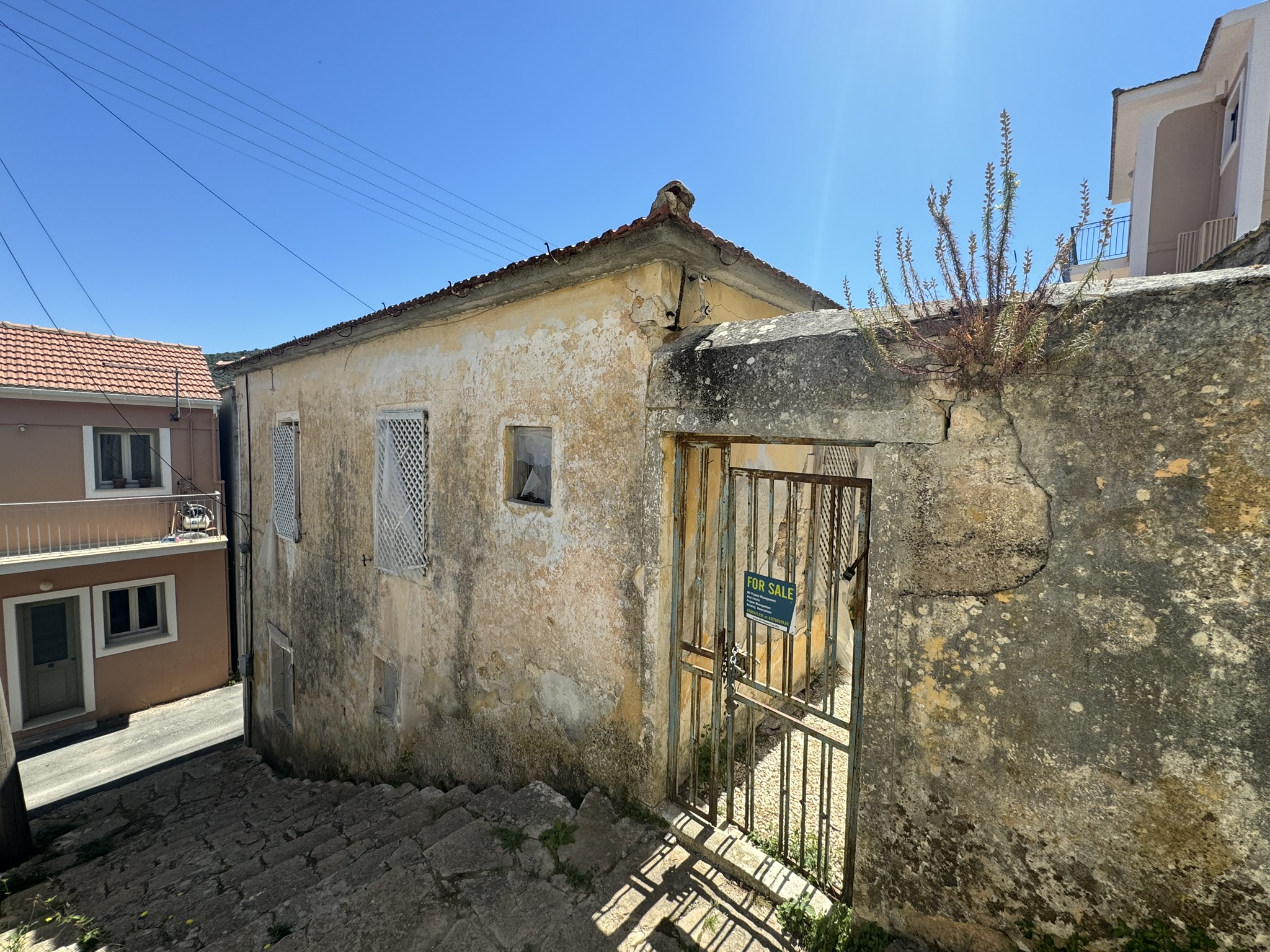 Public stairs and exterior of house for sale in Ithaca Greece Vathi