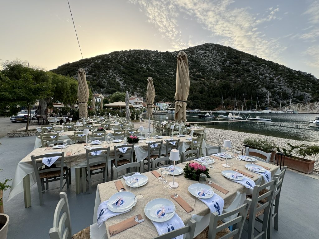 Wedding reception tables at waterfront restaurant in Ithaca Greece, Frikes
