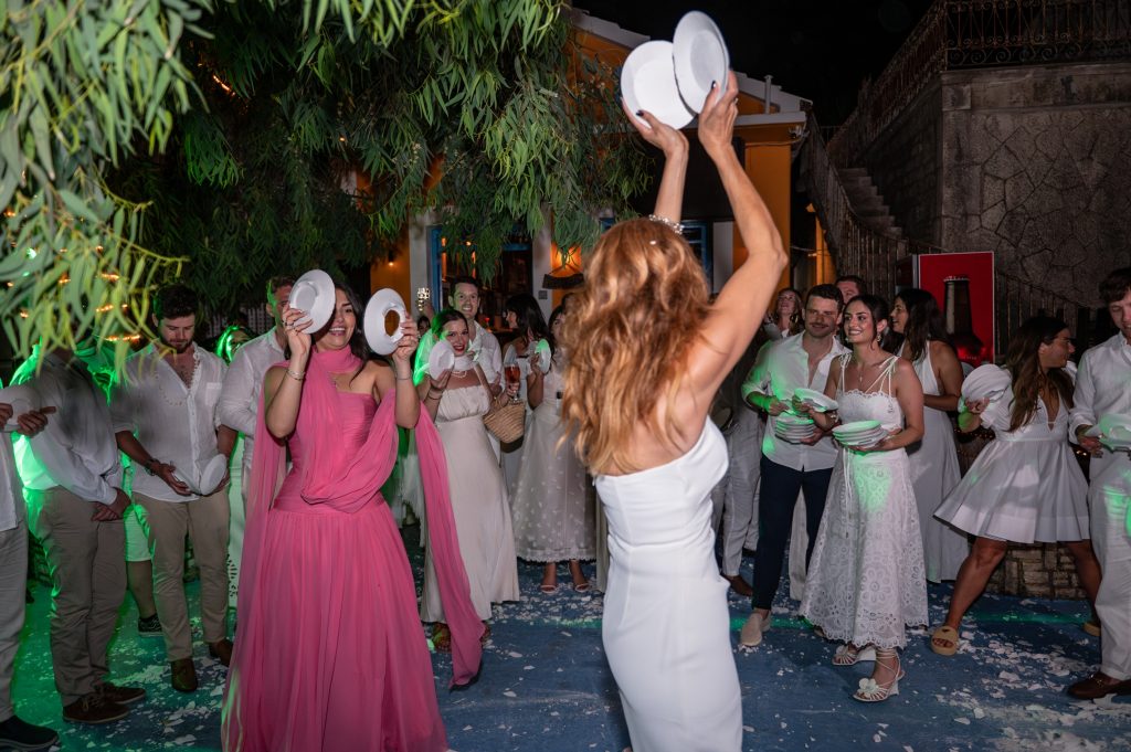 Smashing the plates at Greek wedding reception in Ithaca Greece, Frikes
