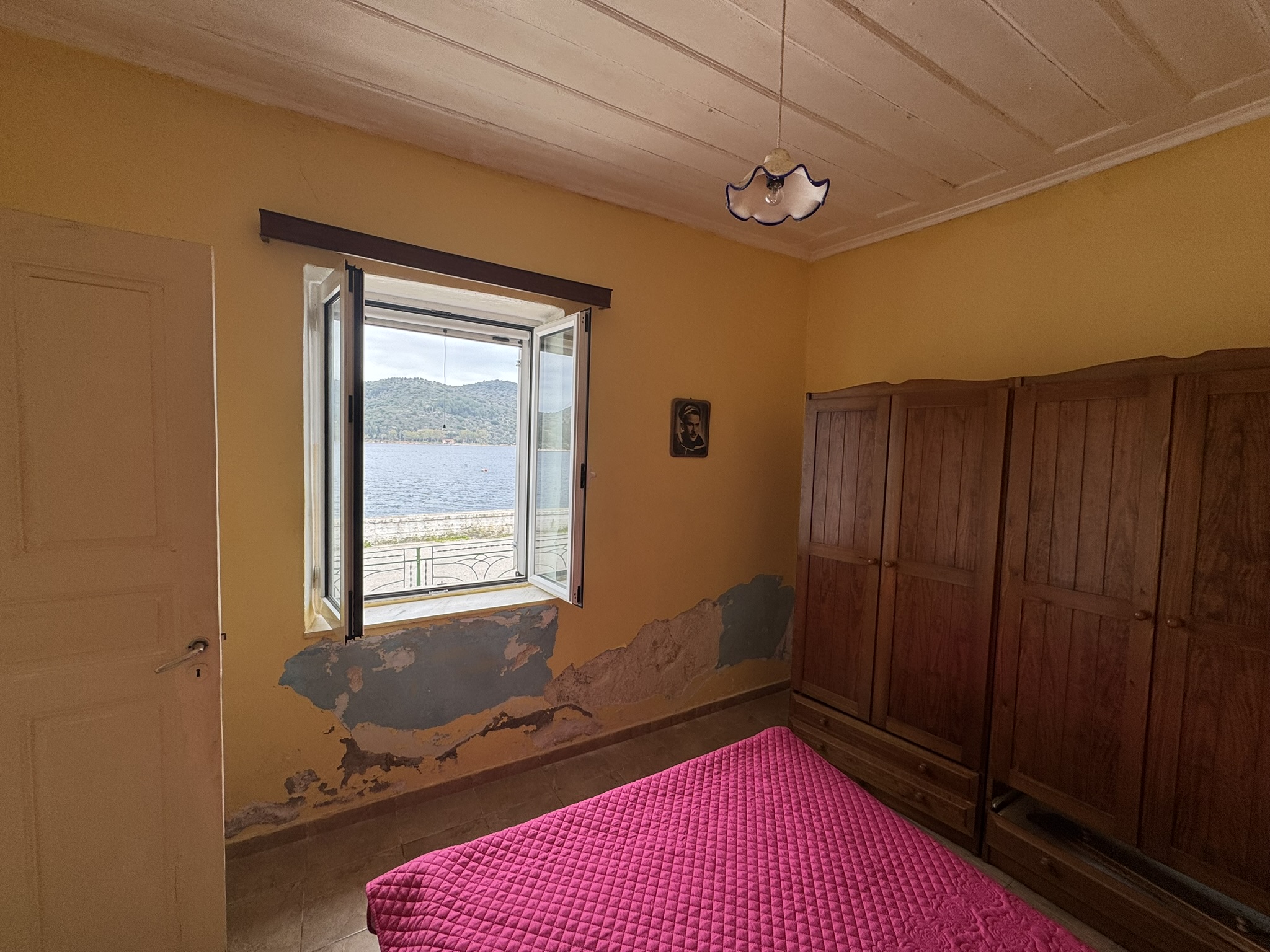 Bedroom of waterfront house for sale in Ithaca Greece, Vathi