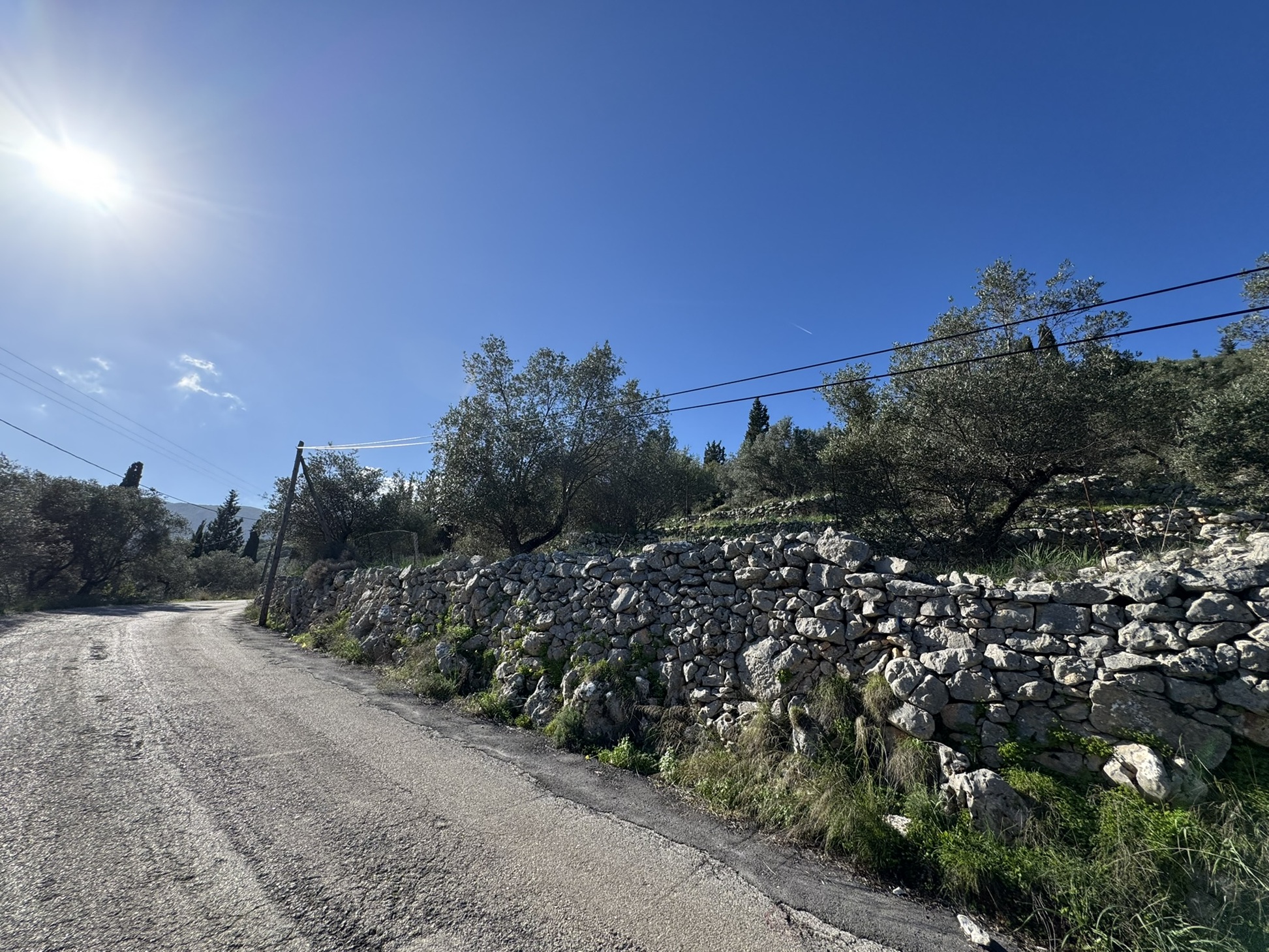 Road view of land for sale in Ithaca Greece, Vathi