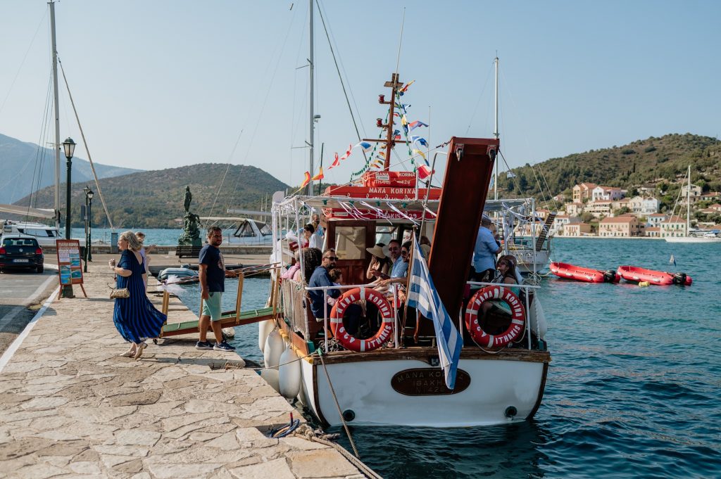 Boat shuttle transporting wedding guests at Lazareto chapel in Ithaca Greece, Vathi