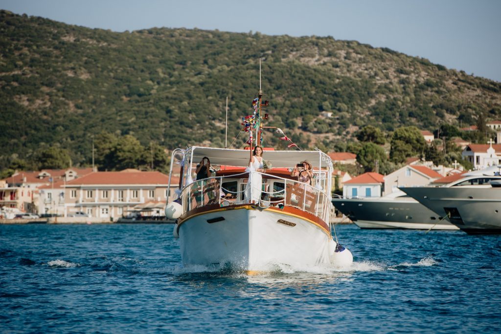 Bride arriving on the boat at Lazareto chapel for wedding in Ithaca Greece, Vathi