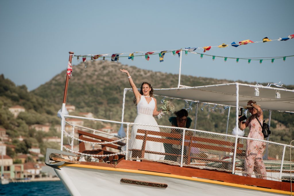 Bride arriving on the boat at Lazareto chapel for wedding in Ithaca Greece, Vathi