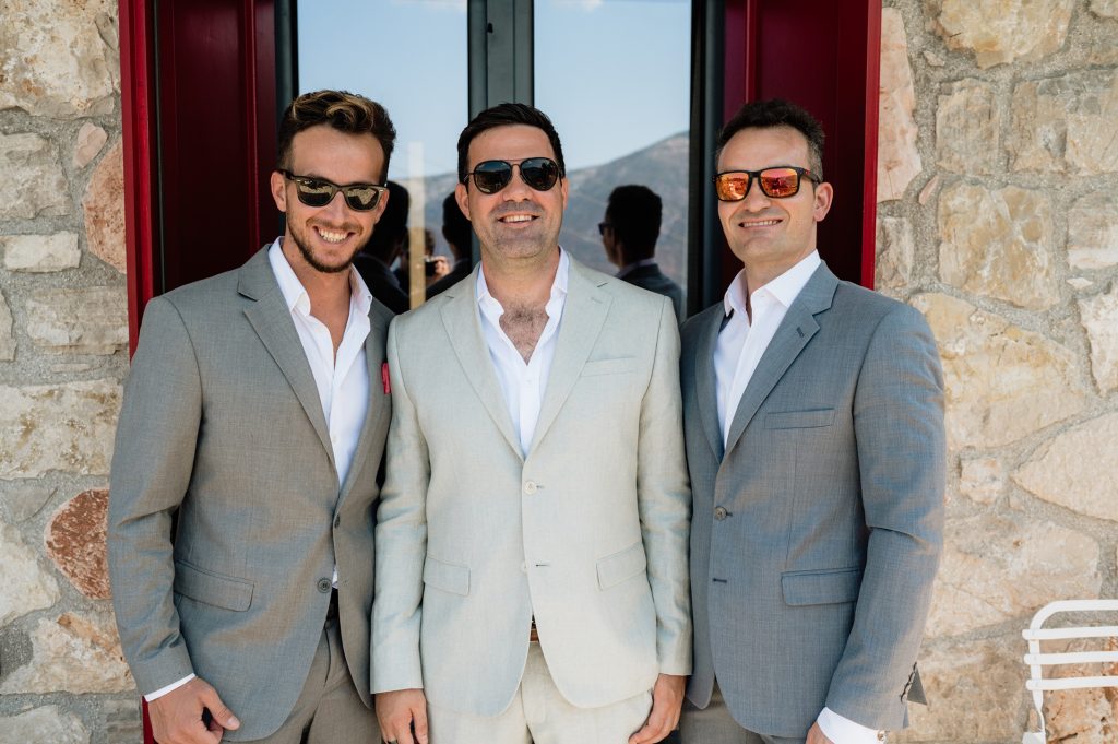 Groom and best men getting dressed for wedding in Ithaca Greece, Vathi