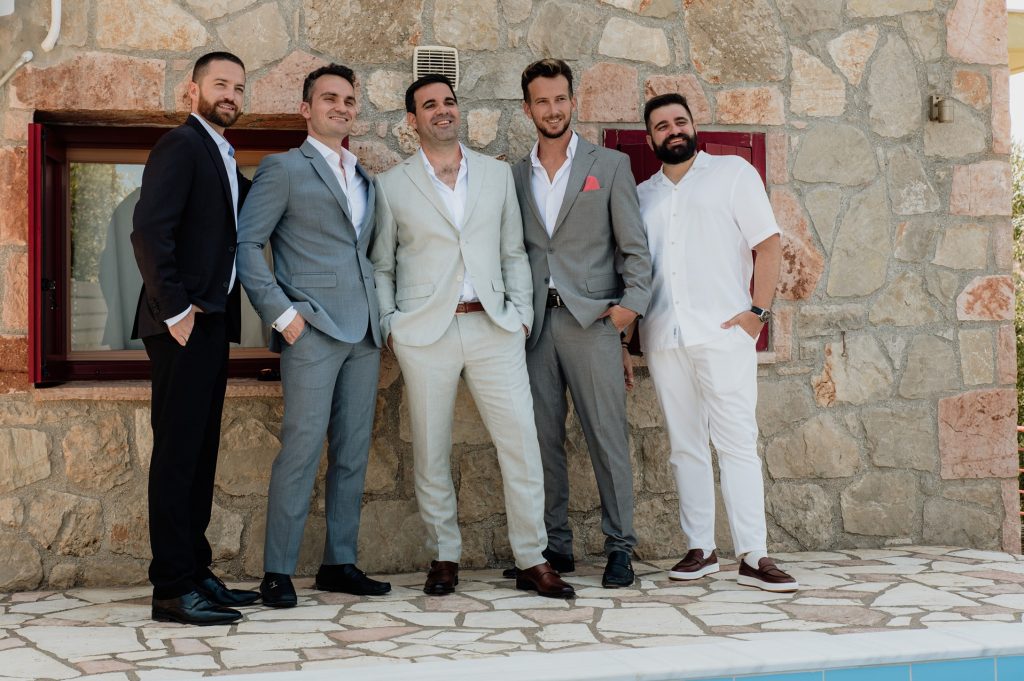 Groom and best men getting dressed for wedding in Ithaca Greece, Vathi