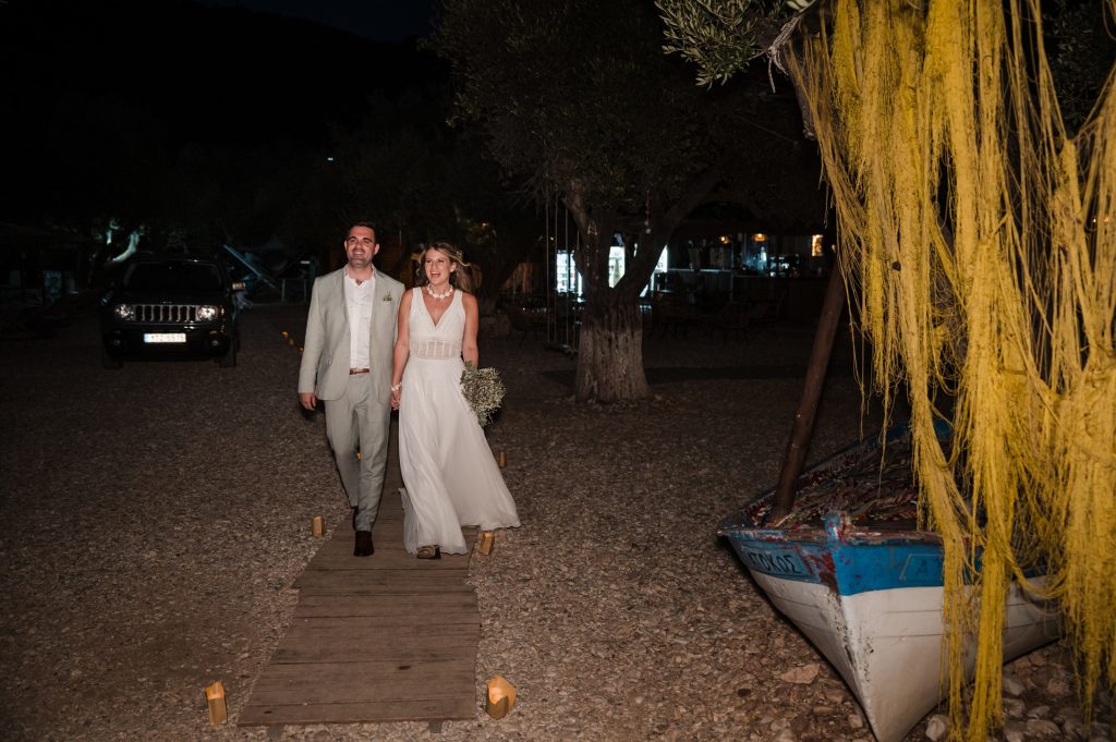 Couple arriving at beach wedding reception in Ithaca Greece, Vathi